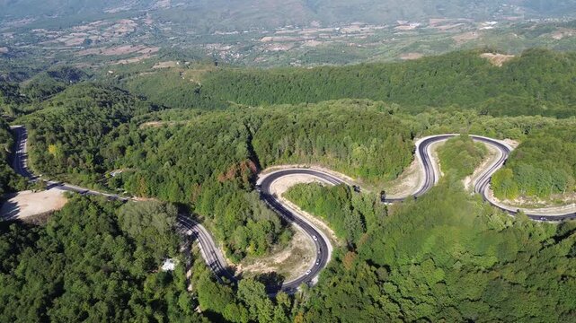 Aerial view of winding asphalt mountain road among green trees in summer. (Domani&ccedil;,İneg&ouml;l dağ yolu)