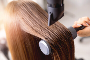 Obraz na płótnie Canvas Professional haircare straightening in salon, Closeup of hair dryer, female stylist