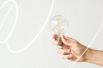 Hand holding a light bulb