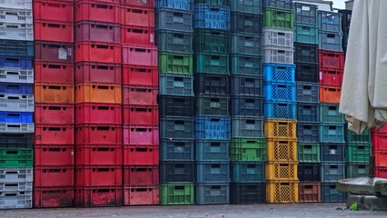 Empty Plastic and Food Fruit Vegetables Crates Stacked Behind Grocery Store Market Stand during...