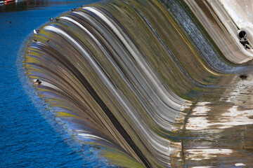 water flowing over dam