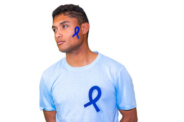 Young man showing blue ribbon for colon cancer awareness month, prostate cancer awareness and...