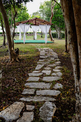 A scenic pathway leading to a beautifully designed gazebo in nature.