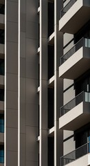 Modern Architecture Marvel: A stunning shot showcasing a contemporary high-rise with geometric elegance. The interplay of light and shadow enhances its modern aesthetic.