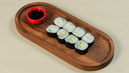Sushi roll on wooden tray