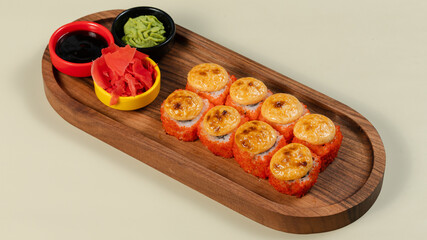 Sushi roll with soy sauce on wooden tray