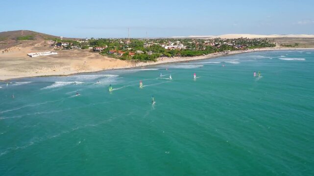 Windsurfers enjoy the turquoise waters of a tropical beach