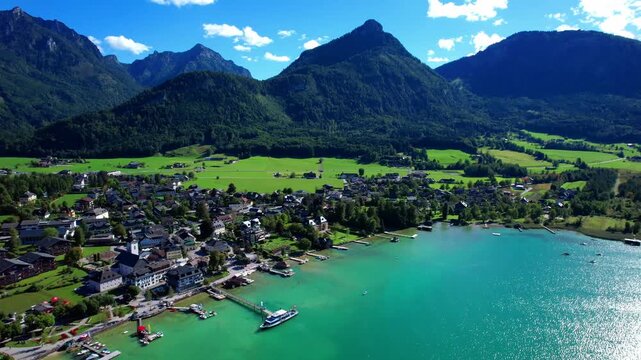 Turquoise Lake Wolfgangsee in the Salzkammergut region of Austria and scenic village Stroble, breathtaking mountains scenery. Austrian tourism and boat cruises. 4k hd footage