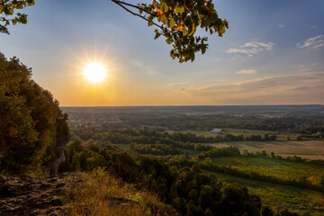 Beautiful sunset view from Mt. Nemo in Burlington, Ontario, showcasing a stunning landscape of fields, forests, and a radiant sky.