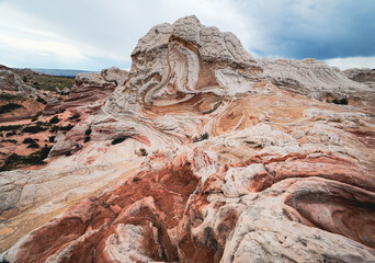 Stunning rock formations with vivid red and white layers in desert landscape