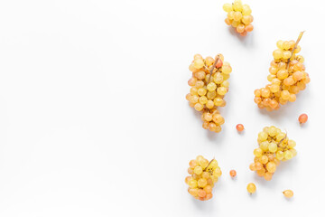 Many bunches of ripe yellow grapes on white background, top view
