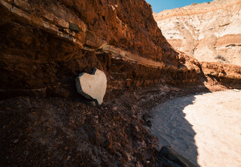 A heart-shaped rock formation nestled within a breathtaking canyon view.