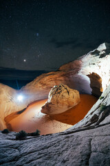Night scene of unique rock formations illuminated under a starry sky