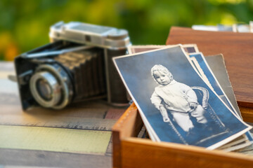 vintage black and white photo baby family archive, wooden box and retro film camera, nostalgia...