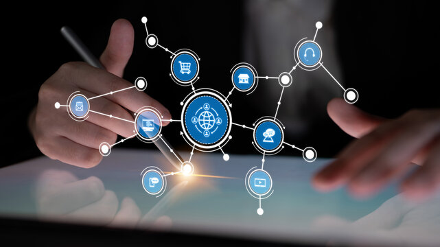 A business professional engages with a tablet, showcasing interconnected social media icons that represent modern communication and online commerce in the workplace. Tessel