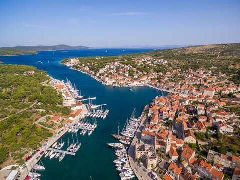 Aerial view of Milna town and marina on Brac island, Croatia, with sailboats, old stone houses, and Mediterranean landscape