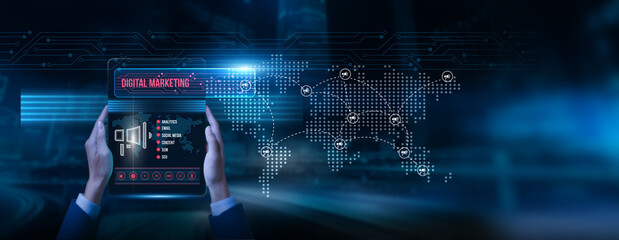Marketer holding a tablet with digital marketing data on the screen: campaign strategy online...