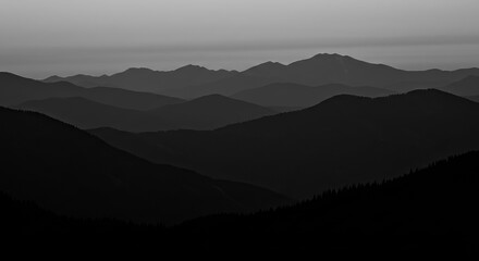Dramatic dark mountain range silhouettes at dusk evoke a sense of awe and mystery
