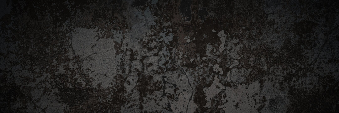 Dark wide panoramic background. Peeling paint on a concrete wall. Dark grunge texture of old cracked flaking paint. Weathered rough painted surface. Patterns of cracks. Darkness background for design.