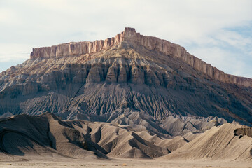 Dramatic carved rocks display unique textures against the vast landscape backdrop.