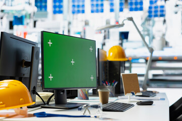 Isolated copy space display on laptop in solar cell manufacturing plant, solar power engineering for sustainable solutions and cheaper energy. Empty desk in a high tech factory.
