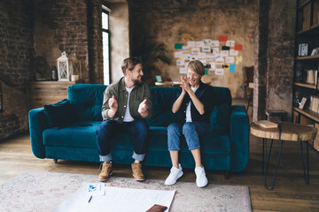 Young entrepreneurs share a celebratory high‑five while viewing data on a laptop, illustrating tech‑driven teamwork, digital success, agile startup flow, collaborative analytics, innovation momentum.