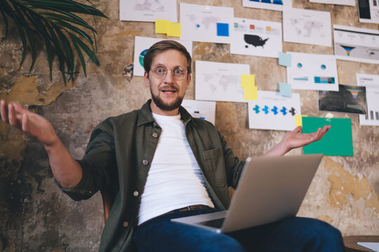 Freelancer gesturing while explaining UX idea during video call, engaged in animated discussion about product development and user logic in collaborative tech session.