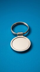 Steel key ring on blue paper background Blank key chain or fashion accessory for your design Can put