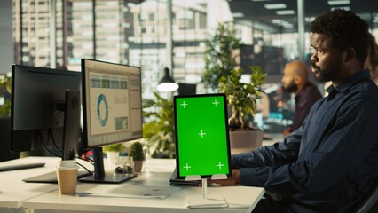 Close up of isolated screen tablet used by worker in office reviewing financial graphs. Employee...