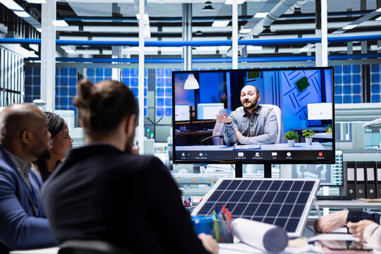 Shareholders assessing deal feasibility during remote videoconference. Investors in solar panels factory performing financial analysis during online videocall to project investment performance