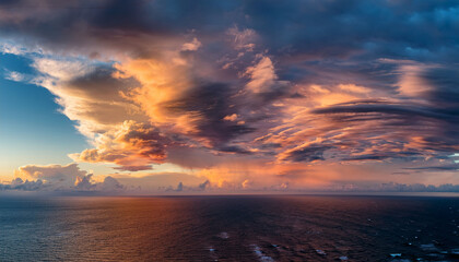 Obraz premium Majestic Swirl Of Clouds And Colors Over Ocean Horizon At Sunset Creating A Breathtaking Natural Phenomenon