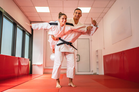Judo couple having fun training and playing in dojo - Powered by Adobe