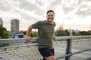 Man smiling enjoying urban outdoor fitness lifestyle © Miljan Živković