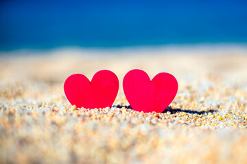 Fototapeta premium romantic symbol of two hearts on the beach 