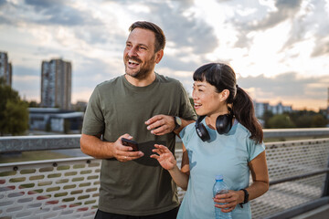 Couple taking a break from jogging in city