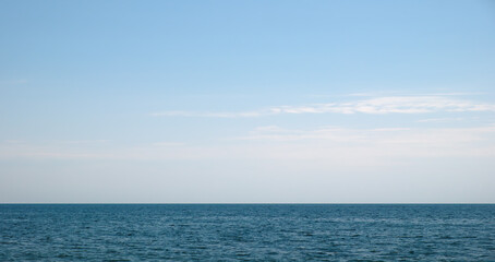 Blue sea waters and clear blue sky horizon