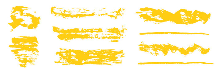 Fototapeta premium Artistic set of grunge hand painted isolated bright mustard yellow ink textured brush strokes. Unique abstract crayon pencils drawing squiggles, scribble and scratches for graphic design