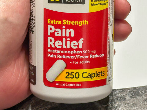 NISSWA, MN - 22 SEP 2025: Hand held bottle of acetaminophen, the generic active ingredient that is als in Tylenol, used to treat pain and fever.