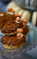 cute mushroom-shaped donuts, sweet forest-themed treats, homemade sweets with mushroom decor, delightful and creative bakery, donuts

