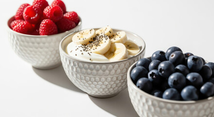 Berry Banana Yogurt Bowls Healthy Breakfast Bowls with Raspberries Blueberries and Sliced Bananas Nutritious Morning Meal with Fresh Fruits and Yogurt