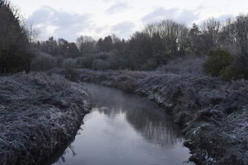 English canal, waterway in winter time with a bit of snow and steam.