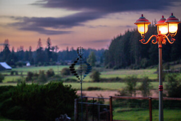 Lamp at sunset with farm fields