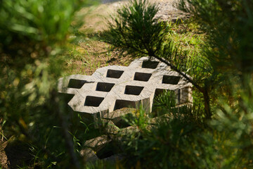 A striking concrete grid pattern beautifully surrounded by lush greenery and plants