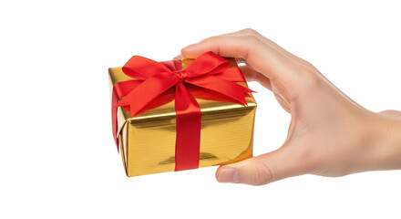 Obraz premium Hand holding a small golden gift box with a red ribbon bow, isolated on transparent background