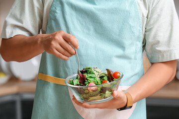 Young man cooking in kitchen