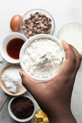 overhead view of All purpose flour in a bowl, top view of baking flour in a ceramic bowl