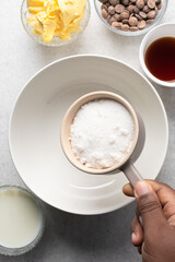 Overhead view of white sugar in a bowl, top view of granulated sugar in a ramekin