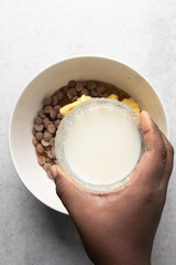 Top view of liquid milk, vegan and alternative milk in a glass bowl, milk for baking
