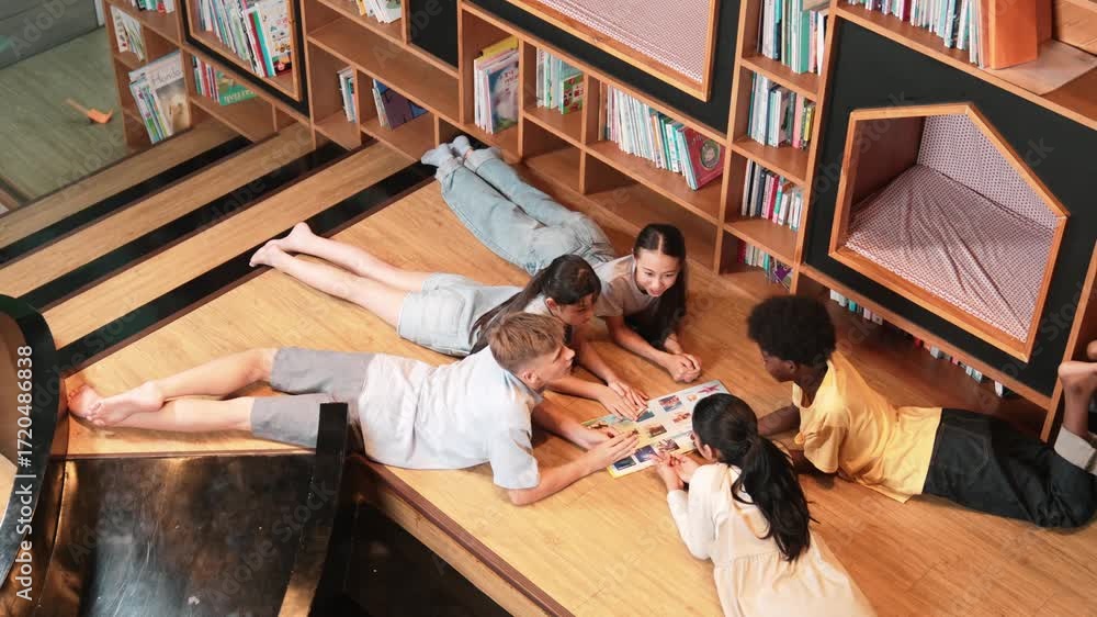 Poster group of diverse children lying down in circle while reading a book at library. top view of girl sha