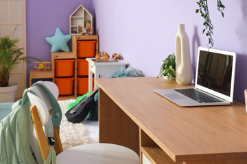 Laptop on study table in children's bedroom